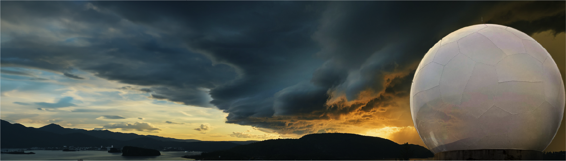 A large, white spherical radar dome stands in the foreground, highlighting its vital applications as dramatic dark storm clouds roll across the sky, with a golden sunset and coastal mountains in the background.